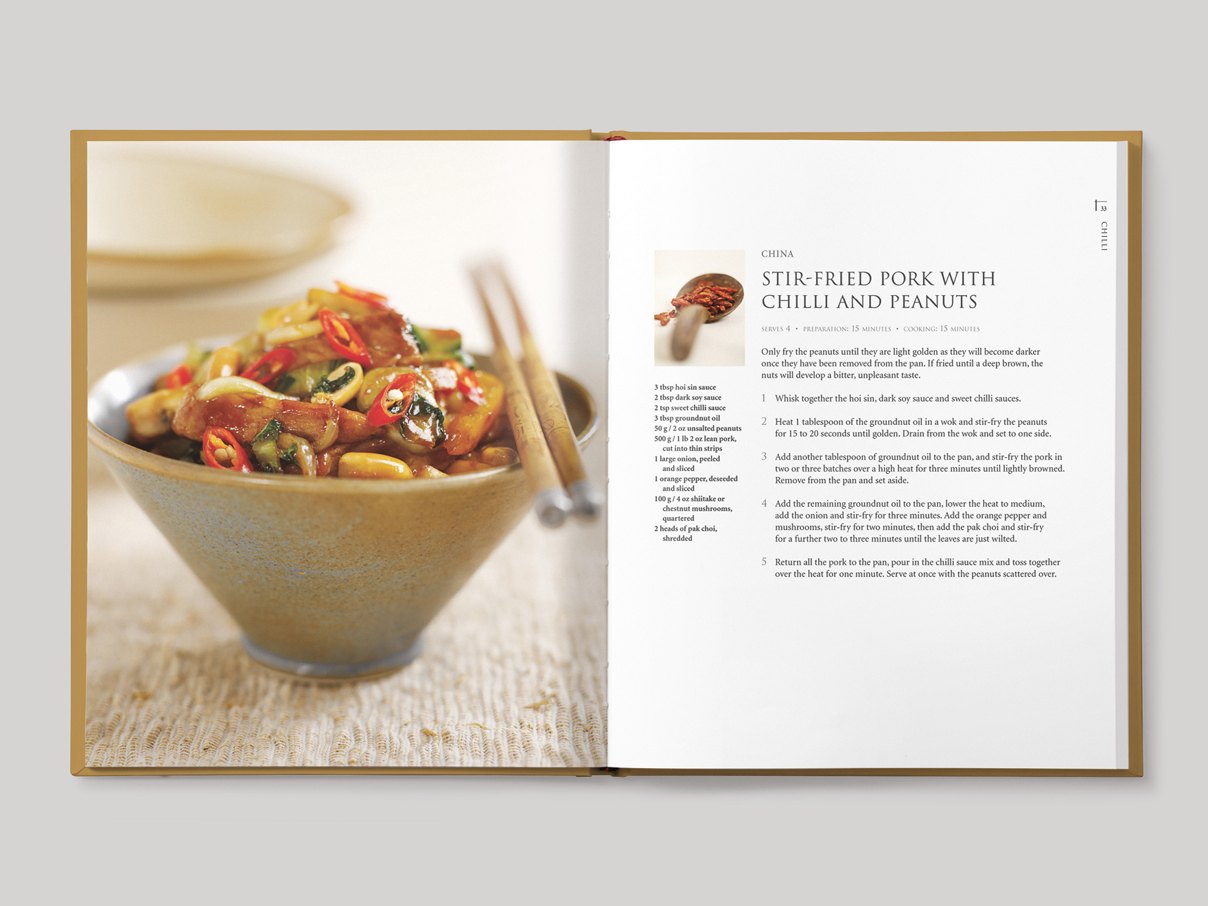 Inside book pages from Asian Flavours showing a recipe for stir-fried pork with chilli and peanuts